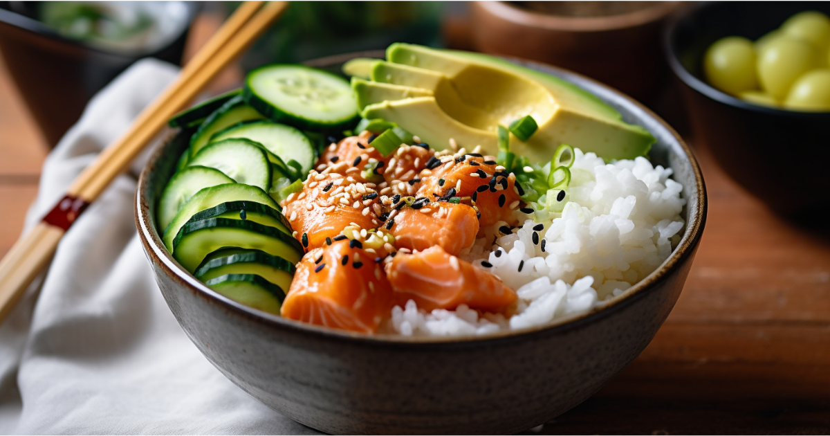 Fresh salmon poke bowl with sushi-grade salmon, rice, avocado, cucumber, and sesame seeds, served with chopsticks on a wooden table